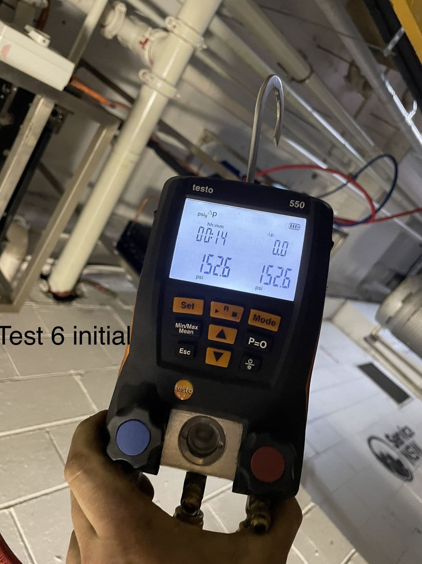 Standby Services technician using a digital manifold gauge to diagnose an air conditioner fault